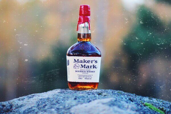 Bottle of bourbon on the ground