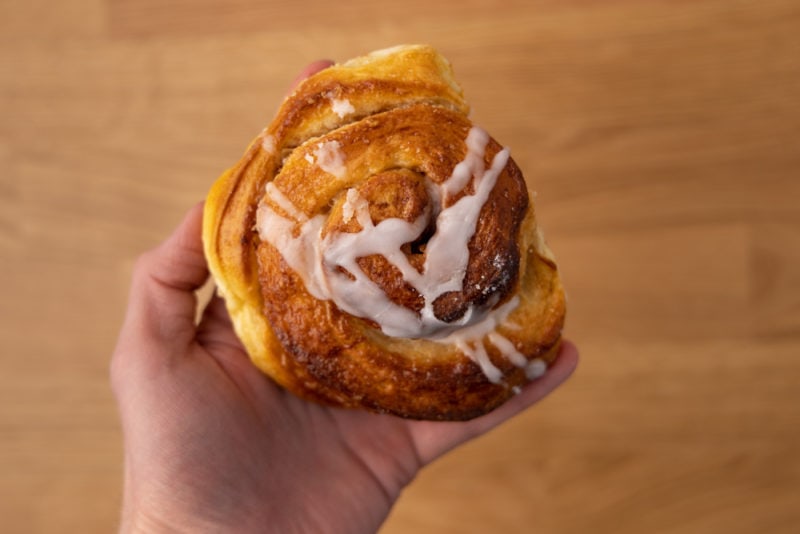 Cinnamon bun in hand